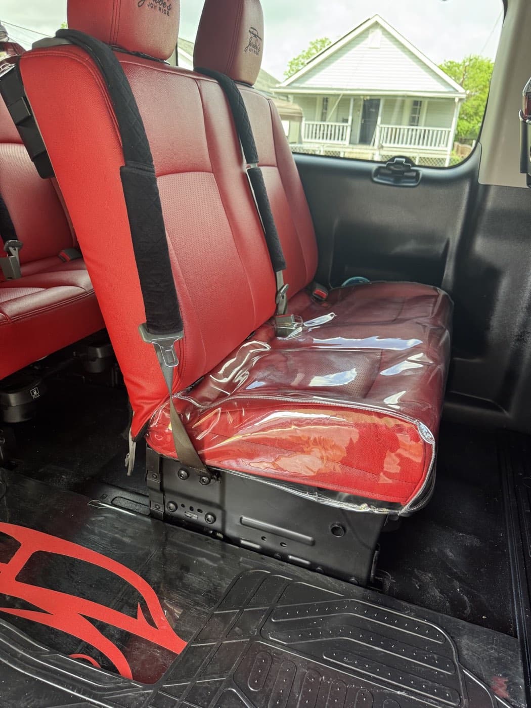 Red passenger seating inside the Joy Ride van