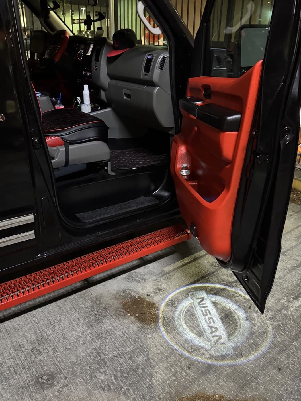 Open front passenger door of the black and red Joy Ride van
