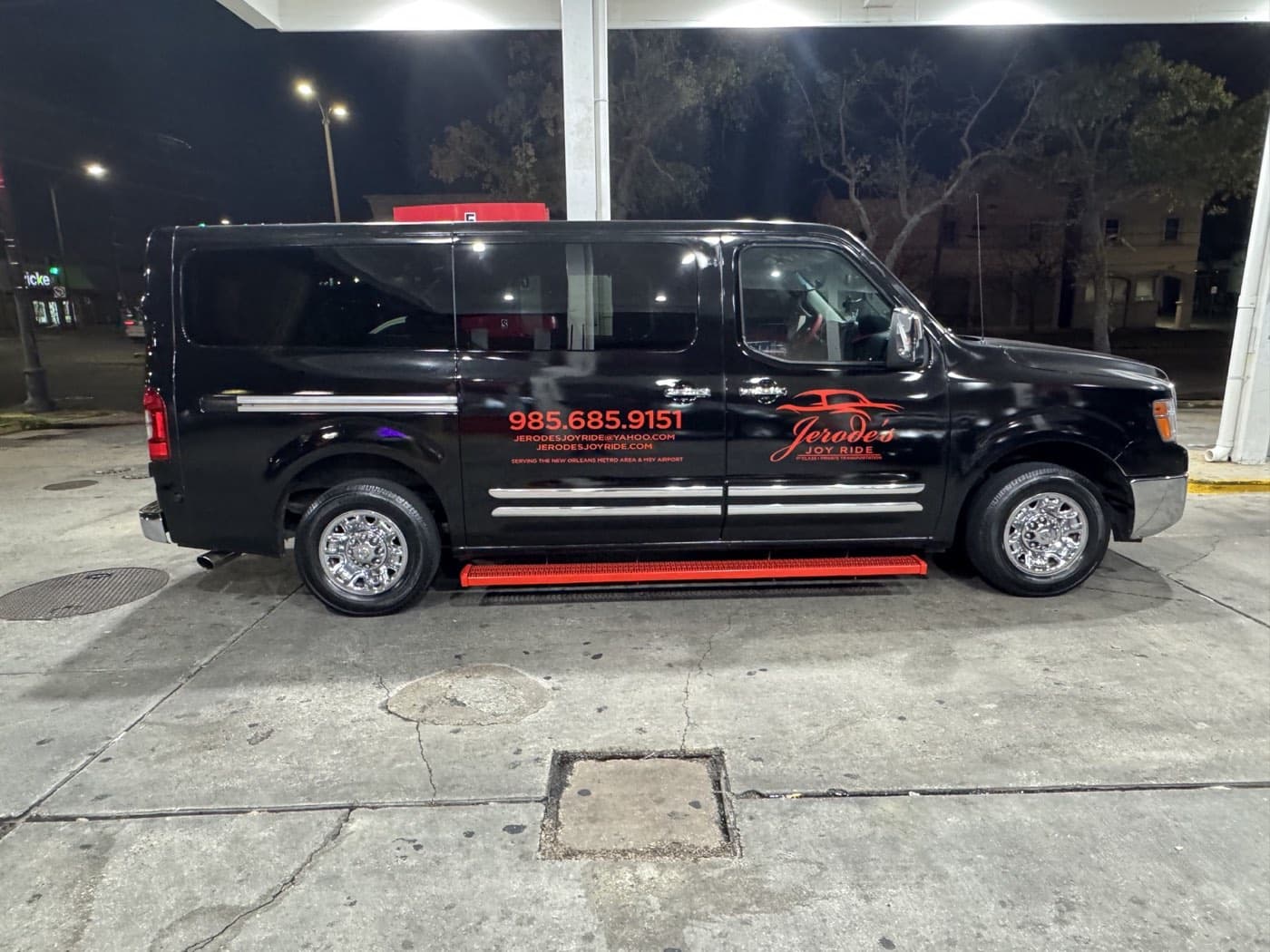 Black Joy Ride passenger van viewed from the side