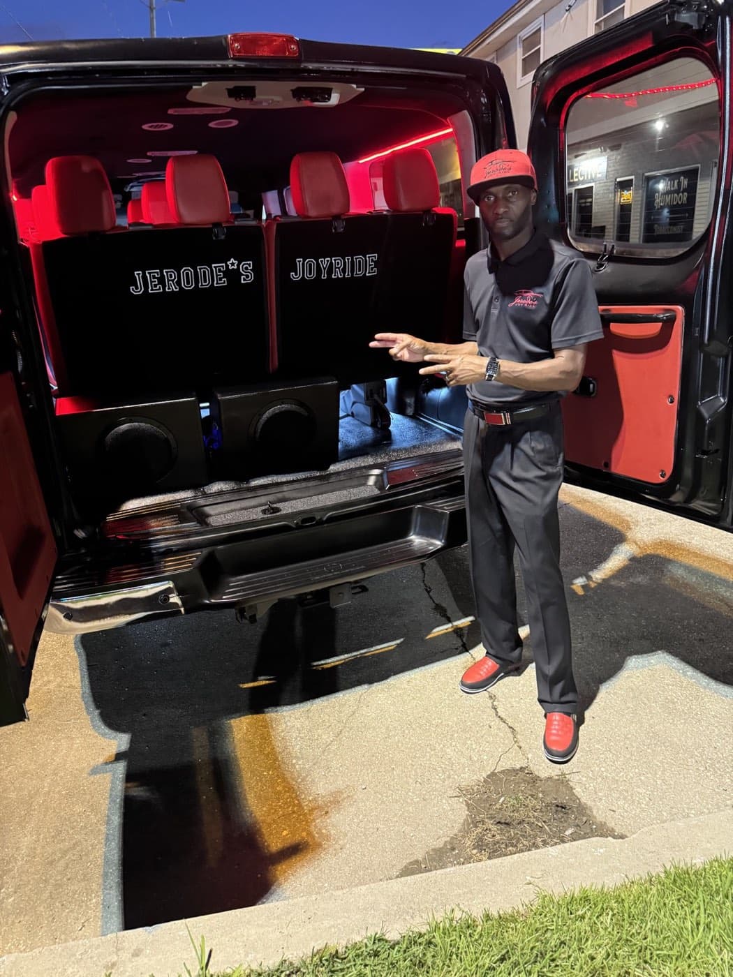 Jerode presenting the red-lit passenger van cabin