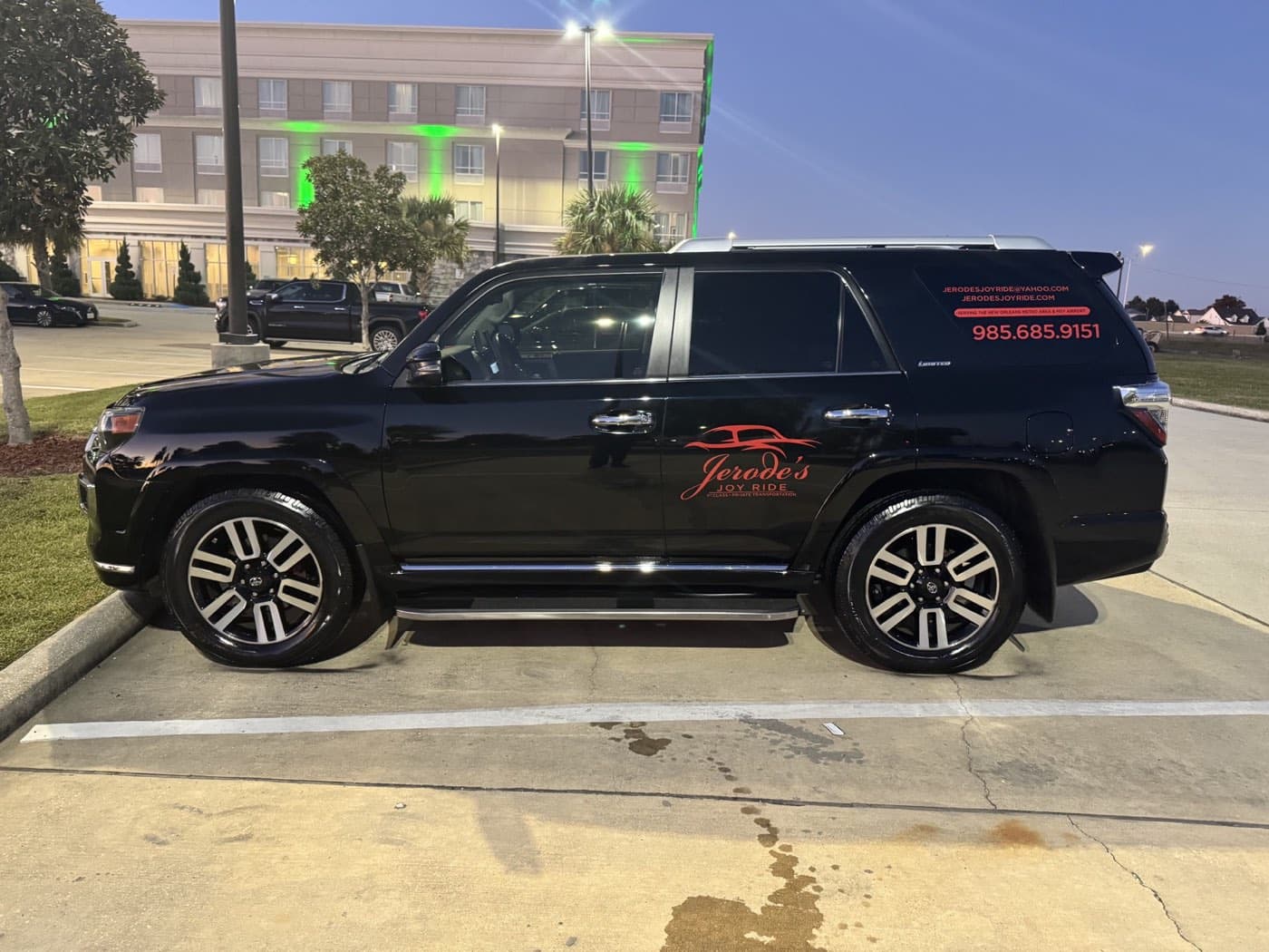 Black Joy Ride SUV parked outside a hotel