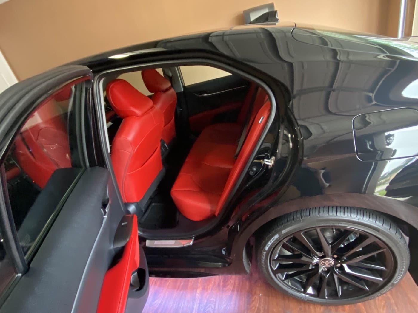 Red leather rear seating inside the black sedan