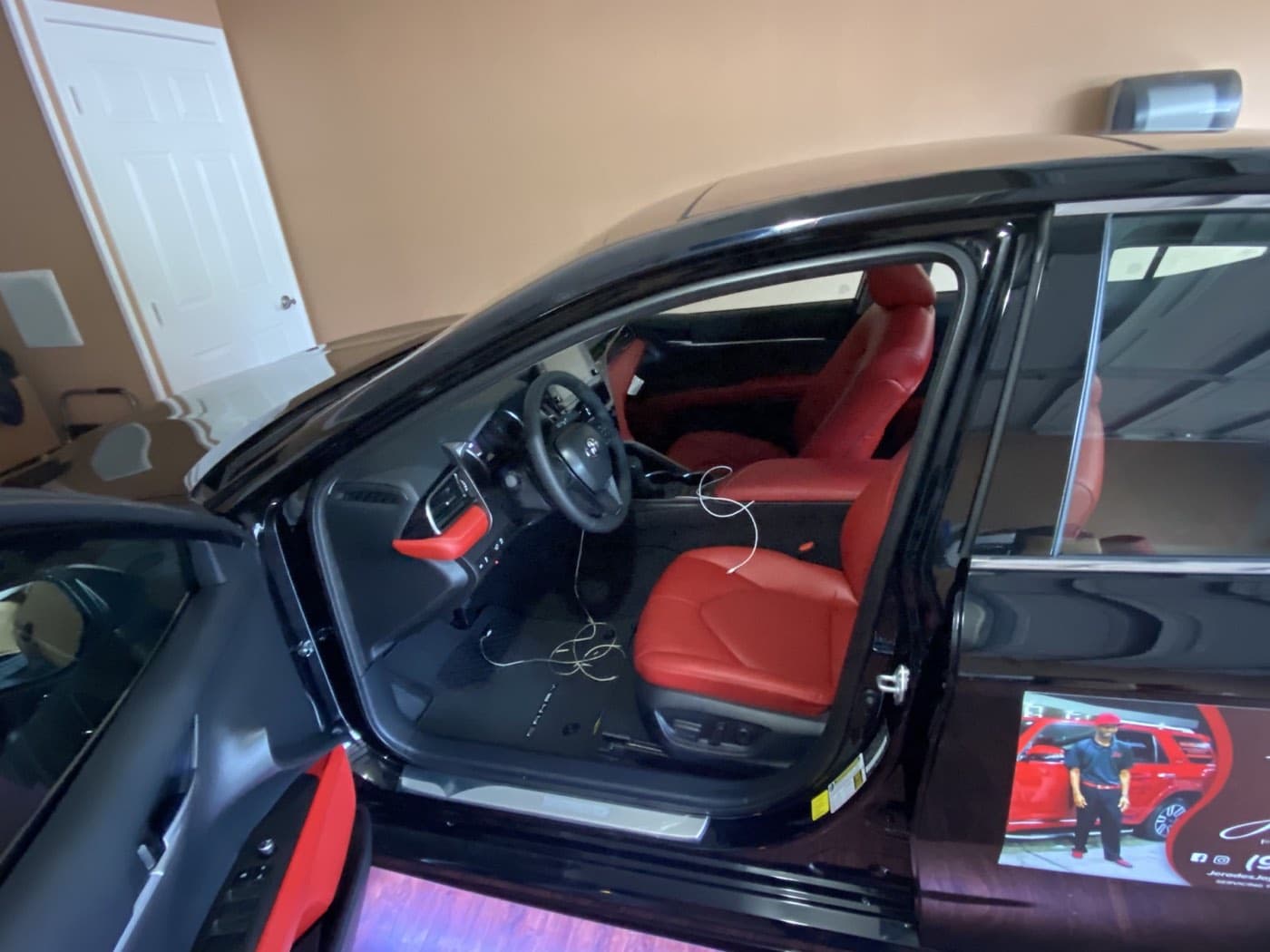 Red leather front seating inside the black sedan